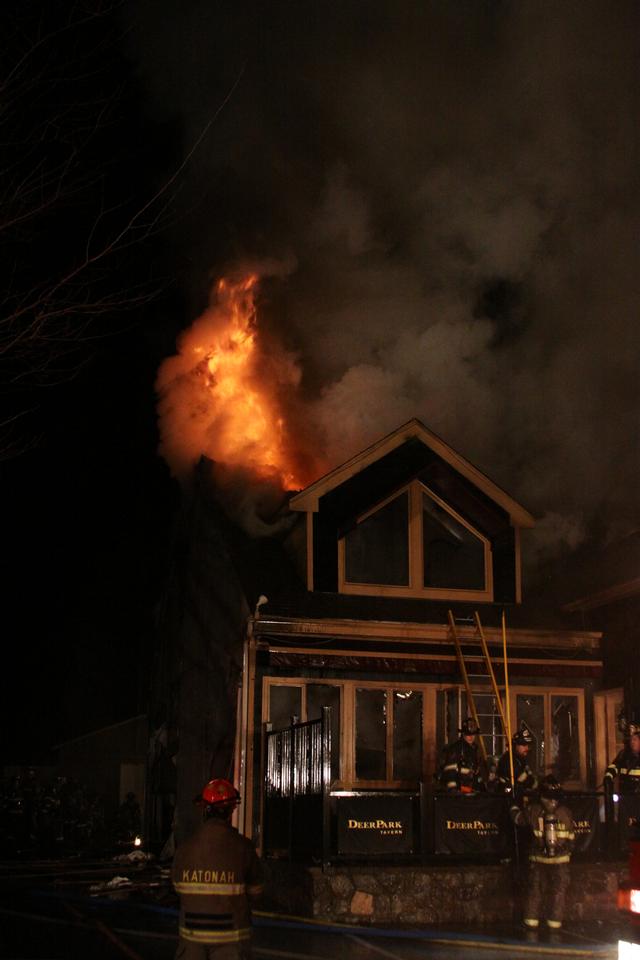 Mutual aid Katonah Old Deer Park Fire. Members getting ready to vent front windows to make access for the deck gun.